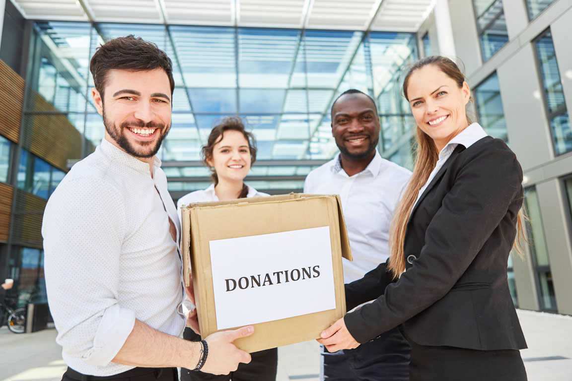 group of business people holding donation box