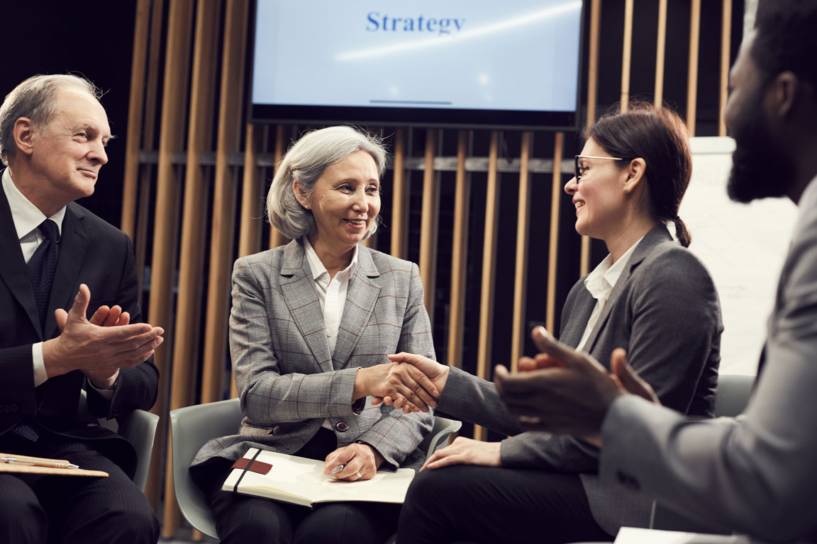 four businesspeople networking at an event
