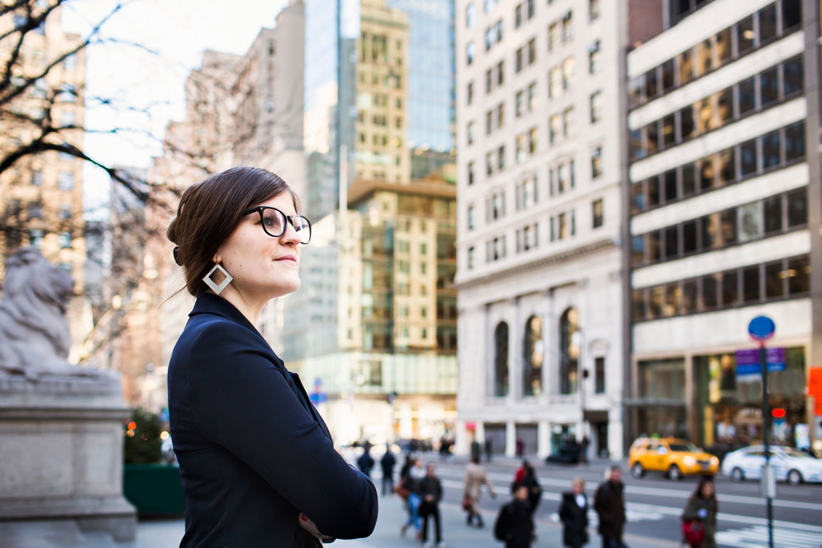 businesswoman standing on New York City sidewalk
