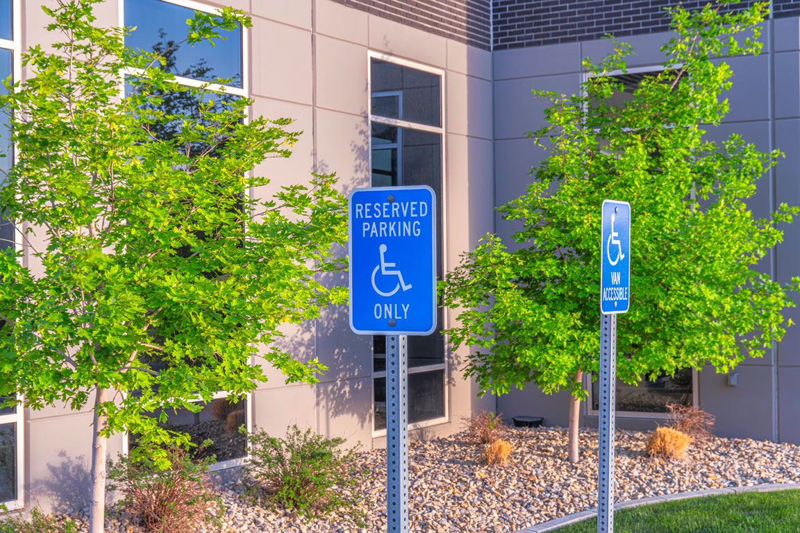 Handicap parking signs in front of office building