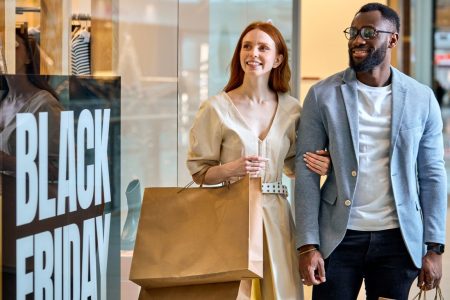 NYB-2 joyful-diverse-couple-taking-part-in-black-friday-2025-03-23-22-48-28-utc diverse couple shopping