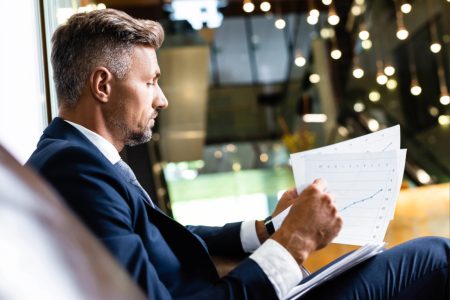 side-view-of-handsome-businessman-in-suit-looking-2026-01-06-00-12-06-utc (1) (1) Business owner looking at fiscal reports