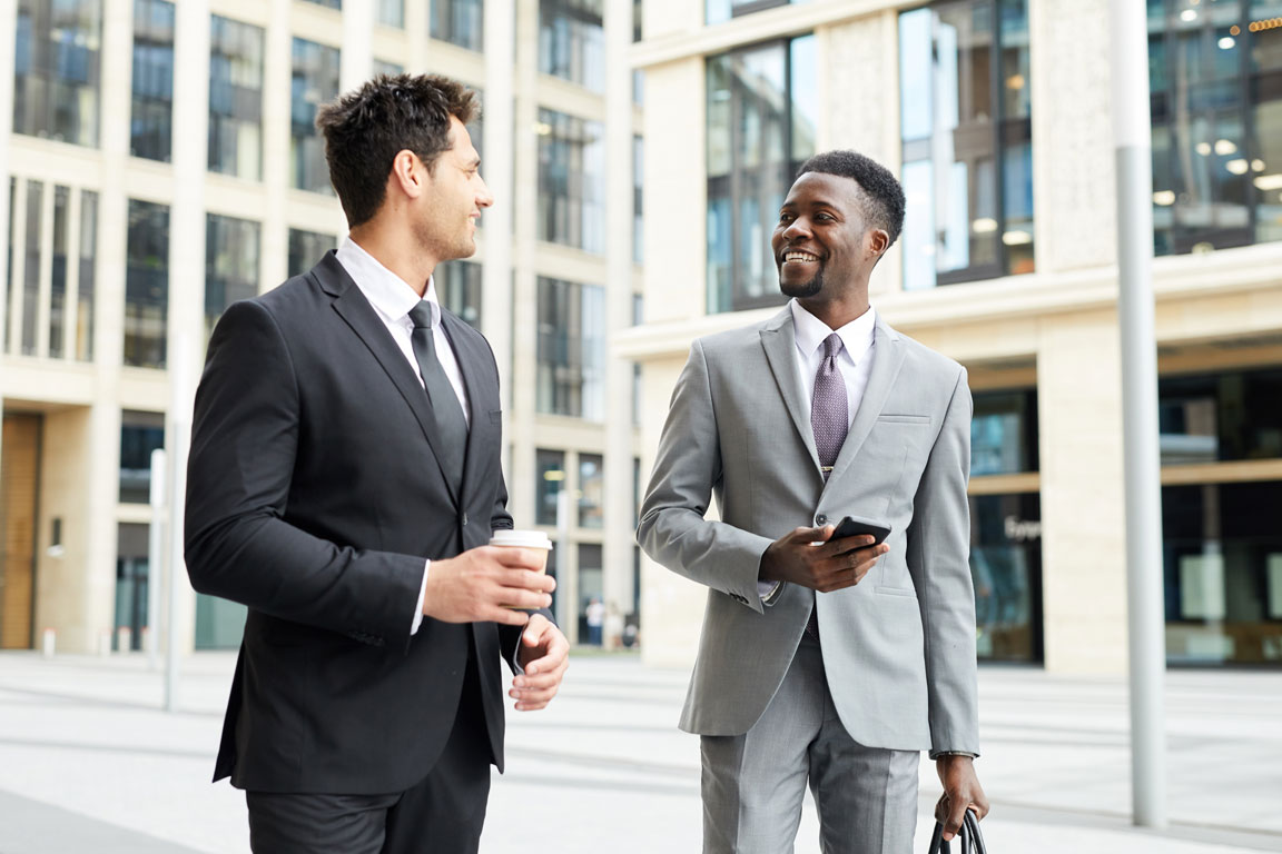 two-colleagues-in-big-city two businessmen talking